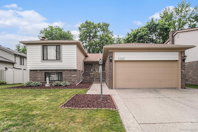3365 Gloucester Dr, Sterling Heights, MI 48310 - tri-level home with brick siding, concrete driveway, and a garage
