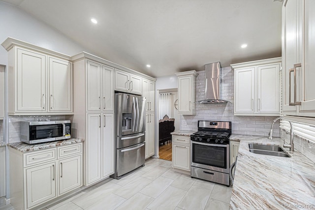 3365 Gloucester Dr, Sterling Heights, MI 48310 - kitchen featuring appliances with stainless steel finishes, wall chimney range hood, a sink, backsplash, and light stone countertops