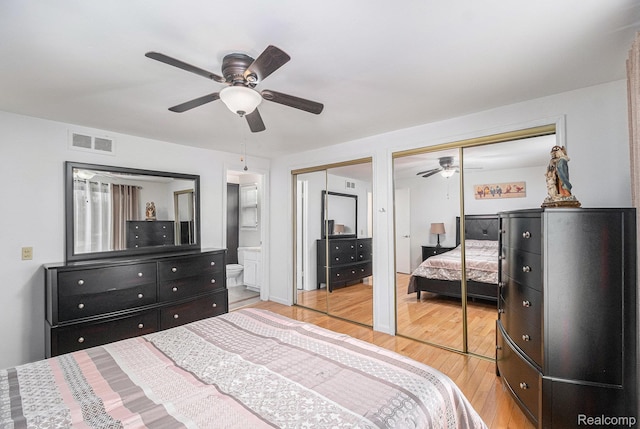 3365 Gloucester Dr, Sterling Heights, MI 48310 - bedroom featuring two closets, light wood-type flooring, ceiling fan, and connected bathroom