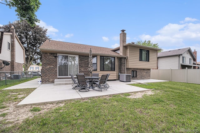 3365 Gloucester Dr, Sterling Heights, MI 48310 - back of house with brick siding, a patio, a chimney, and central air condition unit