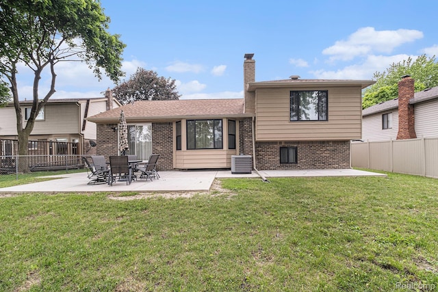 3365 Gloucester Dr, Sterling Heights, MI 48310 - rear view of property featuring brick siding, a patio, a chimney, and central AC