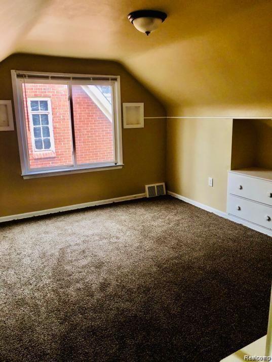 16191 Stoepel St, Detroit, MI 48221 - bonus room with vaulted ceiling, carpet floors, and baseboards