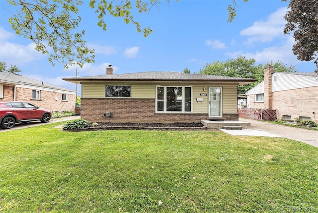 26809 Bonnie Ave, Warren, MI 48089 - view of front of home with brick siding, a chimney, and a front yard