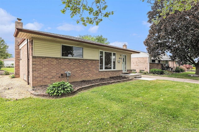 26809 Bonnie Ave, Warren, MI 48089 - ranch-style house featuring a chimney, brick siding, and a front yard