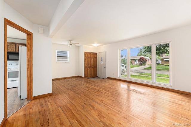 26809 Bonnie Ave, Warren, MI 48089 - unfurnished living room featuring healthy amount of natural light, light wood finished floors, and baseboards