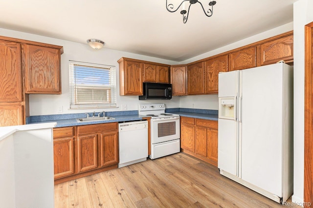 26809 Bonnie Ave, Warren, MI 48089 - kitchen featuring white appliances, a sink, brown cabinetry, and light wood-type flooring