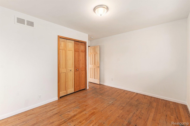 26809 Bonnie Ave, Warren, MI 48089 - unfurnished bedroom with baseboards, light wood-style flooring, and a closet