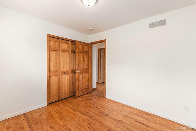 26809 Bonnie Ave, Warren, MI 48089 - unfurnished bedroom featuring baseboards, light wood finished floors, and a closet