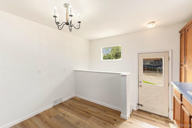 26809 Bonnie Ave, Warren, MI 48089 - unfurnished dining area featuring a chandelier, light wood-type flooring, and baseboards