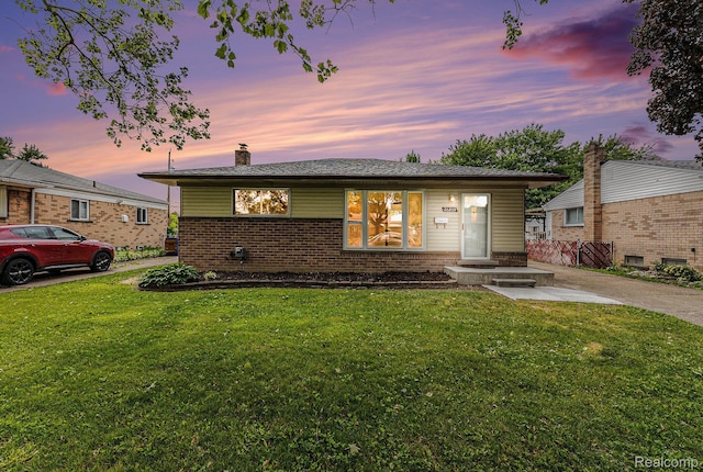 26809 Bonnie Ave, Warren, MI 48089 - view of front of house with brick siding, a chimney, and a front lawn