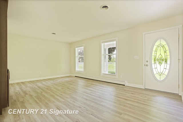 4769 S Fordney Rd, Hemlock, MI 48626 - foyer with baseboard heating, light wood finished floors, healthy amount of natural light, and baseboards
