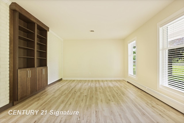 4769 S Fordney Rd, Hemlock, MI 48626 - empty room featuring light wood finished floors, a baseboard radiator, and baseboards