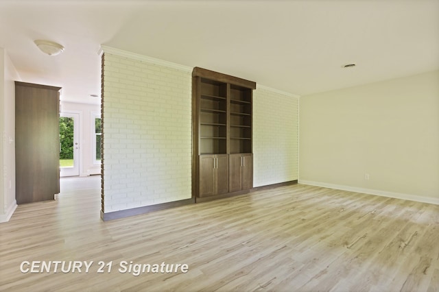 4769 S Fordney Rd, Hemlock, MI 48626 - empty room with brick wall, light wood finished floors, baseboards, and crown molding