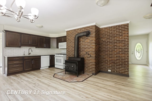 4769 S Fordney Rd, Hemlock, MI 48626 - kitchen featuring white appliances, a sink, light wood-style flooring, dark brown cabinets, and a chandelier