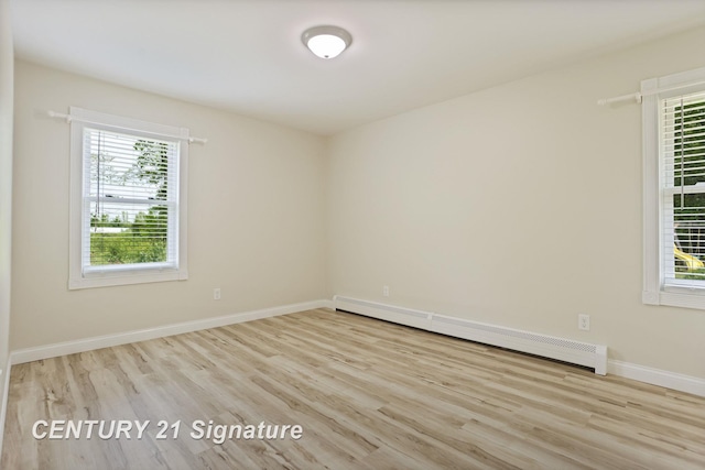 4769 S Fordney Rd, Hemlock, MI 48626 - spare room with baseboard heating, wood finished floors, and baseboards