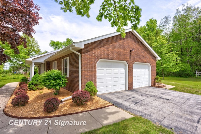 4769 S Fordney Rd, Hemlock, MI 48626 - view of front of property with brick siding, a garage, and a front lawn