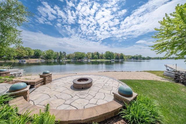 7899 W Royal Rd, Canadian Lakes, MI 49346 - view of patio featuring an outdoor fire pit and a water view