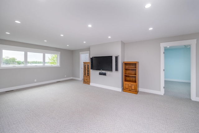 7899 W Royal Rd, Canadian Lakes, MI 49346 - unfurnished living room featuring light carpet and recessed lighting