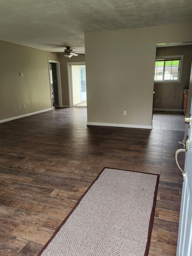 179 W State St, Coldwater, MI 49036 - unfurnished living room featuring a ceiling fan, hardwood / wood-style flooring, and a textured ceiling