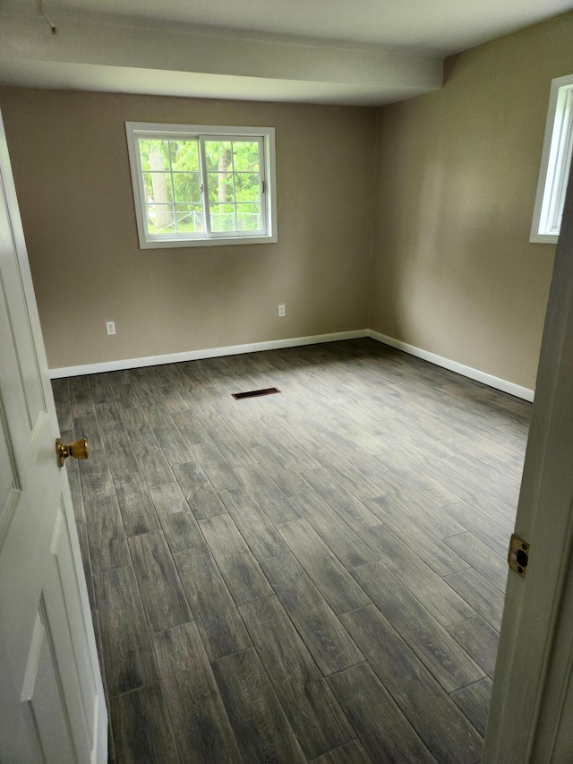 179 W State St, Coldwater, MI 49036 - spare room with dark wood-type flooring and baseboards