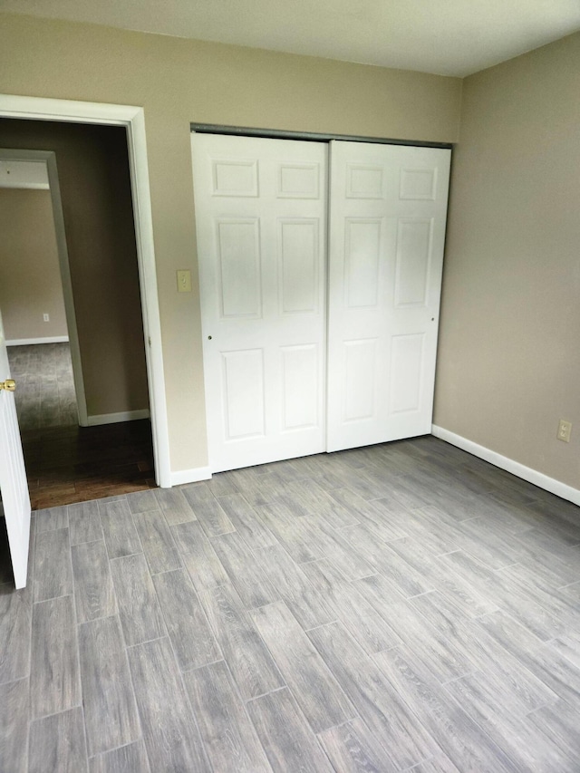 179 W State St, Coldwater, MI 49036 - unfurnished bedroom with wood finished floors and a closet