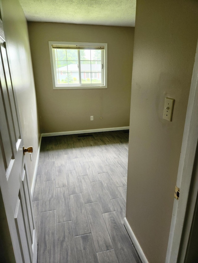 179 W State St, Coldwater, MI 49036 - unfurnished room with wood finished floors and a textured ceiling