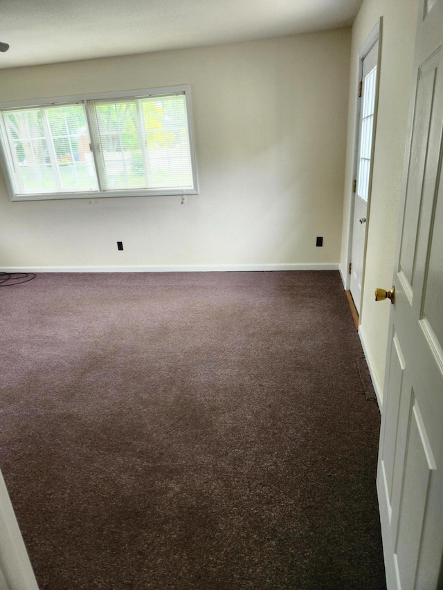 179 W State St, Coldwater, MI 49036 - empty room with dark carpet and baseboards