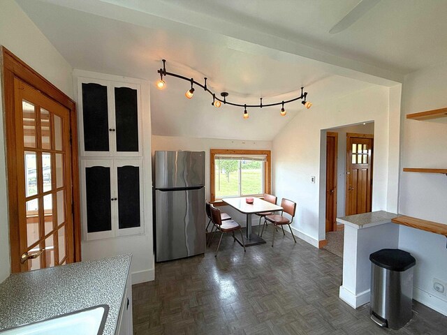 11250 Bristol Rd, Lennon, MI 48449 - kitchen with freestanding refrigerator, baseboards, lofted ceiling, a sink, and light countertops