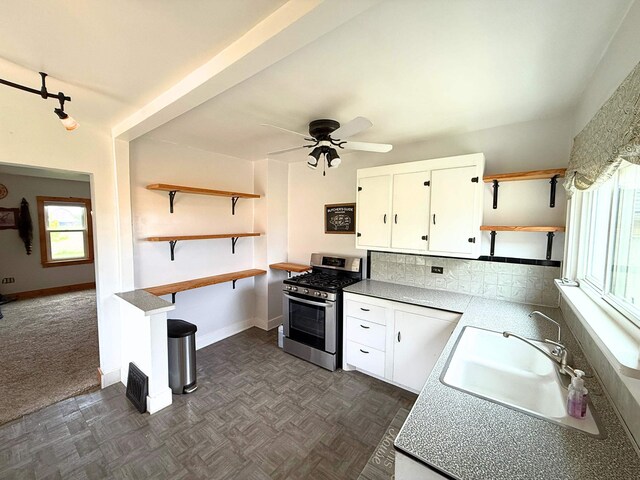 11250 Bristol Rd, Lennon, MI 48449 - kitchen featuring open shelves, stainless steel range with gas cooktop, a sink, and white cabinetry