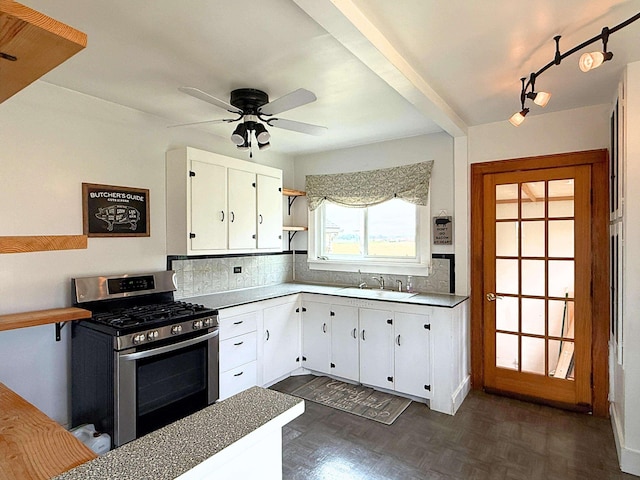 11250 Bristol Rd, Lennon, MI 48449 - kitchen featuring stainless steel gas stove, a sink, tasteful backsplash, and a ceiling fan