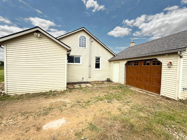 11250 Bristol Rd, Lennon, MI 48449 - rear view of house with an outbuilding, a garage, and a shingled roof