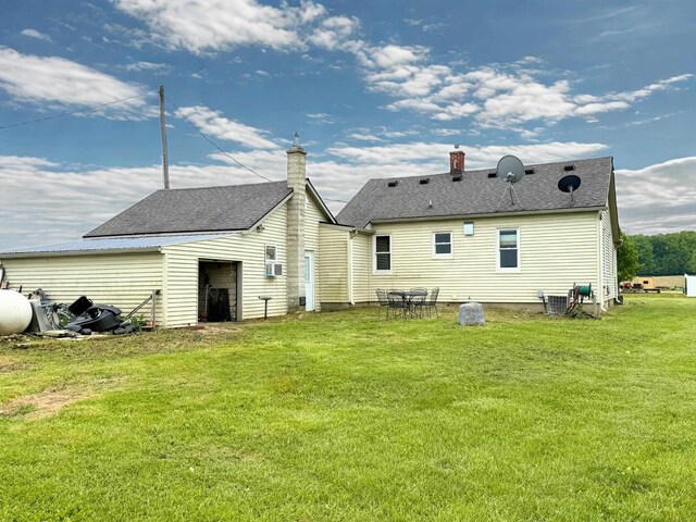 11250 Bristol Rd, Lennon, MI 48449 - rear view of house featuring a lawn, central air condition unit, and roof with shingles