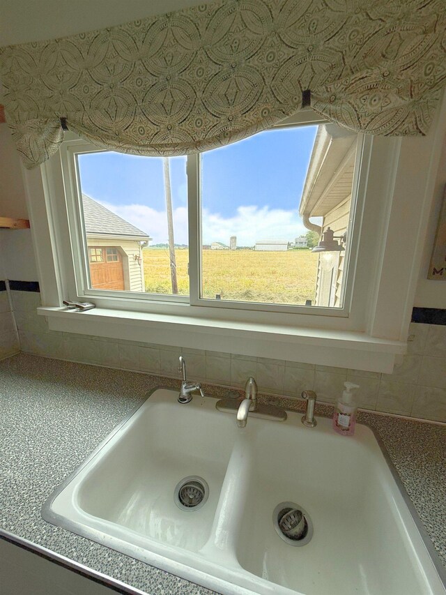 11250 Bristol Rd, Lennon, MI 48449 - kitchen view of a sink, white cabinetry, and decorative backsplash