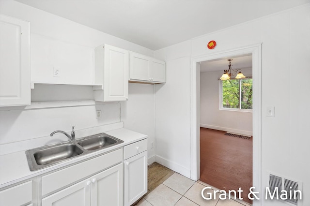 19250 Charest St, Detroit, MI 48234 - kitchen featuring a sink, white cabinetry, light countertops, and baseboards