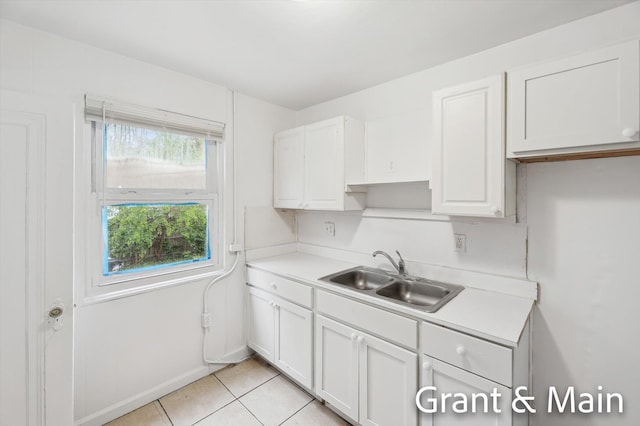 19250 Charest St, Detroit, MI 48234 - kitchen featuring a sink, light countertops, white cabinets, light tile patterned floors, and baseboards
