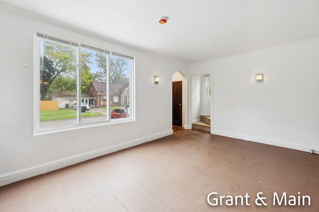 19250 Charest St, Detroit, MI 48234 - empty room with arched walkways, baseboards, ornamental molding, and wood finished floors