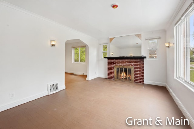 19250 Charest St, Detroit, MI 48234 - unfurnished living room with arched walkways, ornamental molding, baseboards, and a brick fireplace