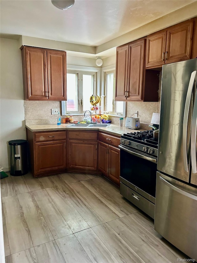 4685 Julius, Westland, MI 48186 - kitchen with appliances with stainless steel finishes, a sink, light countertops, and light wood finished floors