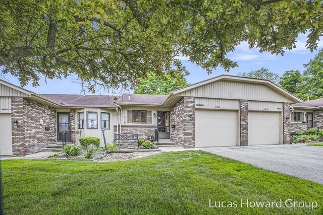 8535 Elkwood Dr SW, Byron Center, MI 49315 - ranch-style home featuring brick siding, an attached garage, driveway, and a front yard