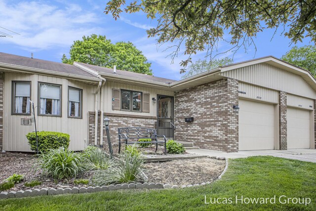 8535 Elkwood Dr SW, Byron Center, MI 49315 - single story home featuring a garage, brick siding, concrete driveway, and roof with shingles