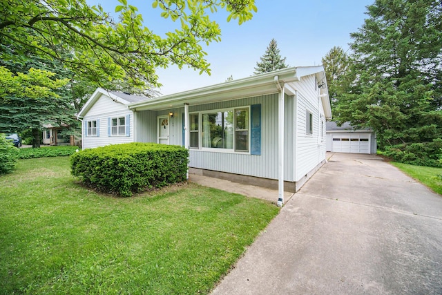 188 Redman Rd, Milan, MI 48160 - ranch-style home featuring a front yard, a porch, an outbuilding, and a detached garage