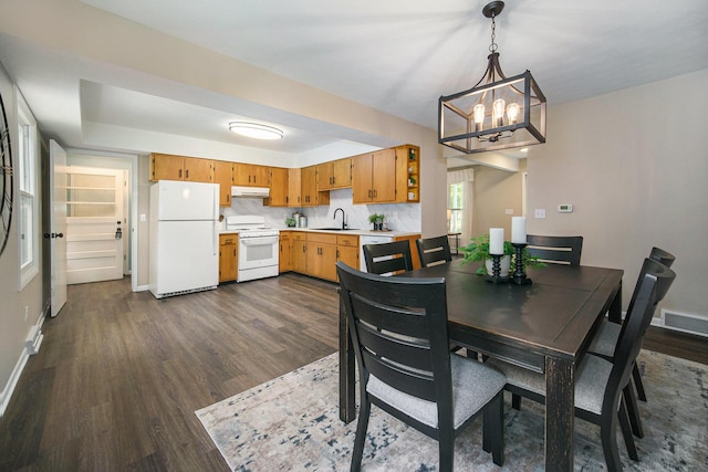 188 Redman Rd, Milan, MI 48160 - dining room featuring baseboards, a chandelier, and dark wood-style floors