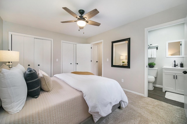 188 Redman Rd, Milan, MI 48160 - bedroom featuring two closets, ensuite bath, a sink, baseboards, and a ceiling fan