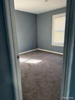 14557 Strathmoor St, Detroit, MI 48227 - empty room with carpet and baseboards