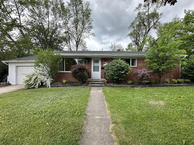 2419 Faye Dr, Ann Arbor, MI 48103 - ranch-style home featuring an attached garage, brick siding, and a front lawn