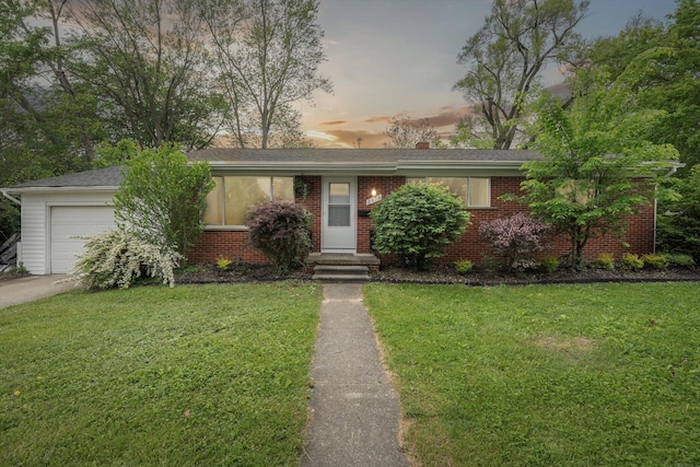 2419 Faye Dr, Ann Arbor, MI 48103 - view of front of house featuring an attached garage, a front yard, and brick siding