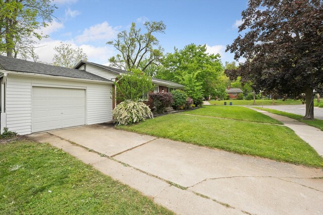 2419 Faye Dr, Ann Arbor, MI 48103 - view of front of home featuring concrete driveway, a front lawn, an attached garage, and roof with shingles