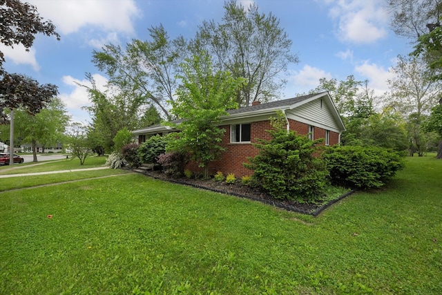 2419 Faye Dr, Ann Arbor, MI 48103 - view of home's exterior with brick siding, a lawn, and a chimney