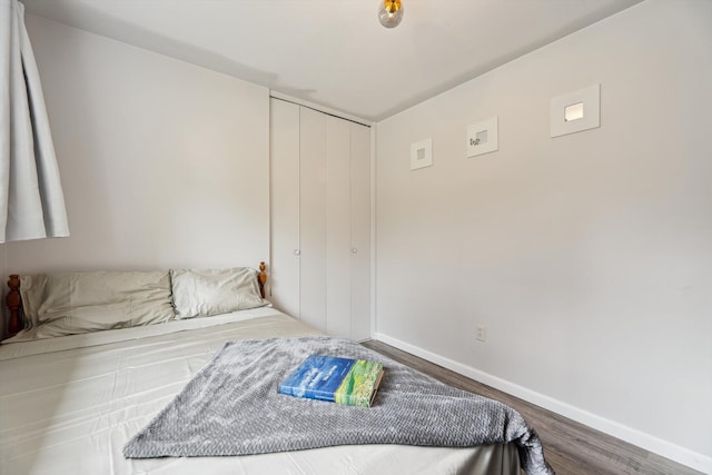 2419 Faye Dr, Ann Arbor, MI 48103 - bedroom featuring wood finished floors, a closet, and baseboards