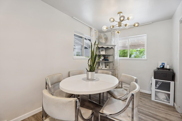 2419 Faye Dr, Ann Arbor, MI 48103 - dining room with a chandelier, baseboards, and wood finished floors